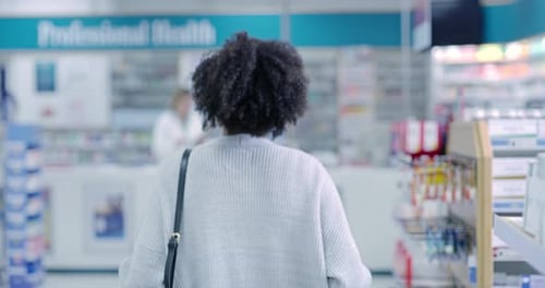 Pharmacy customer shopping shelf medication in medical drugstore, retail service