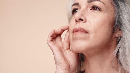 Elegant Mature Woman Touches Her Face