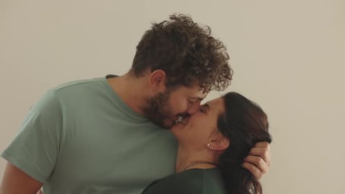 Affectionate Young Couple Kissing in Home Interior