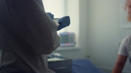 Patient man on clinic couch listening to doctor about covid vaccination