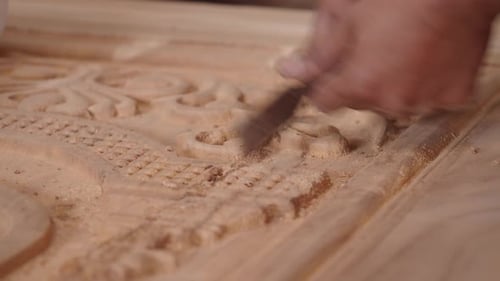 Carving Intricate Wooden Designs in a Workshop