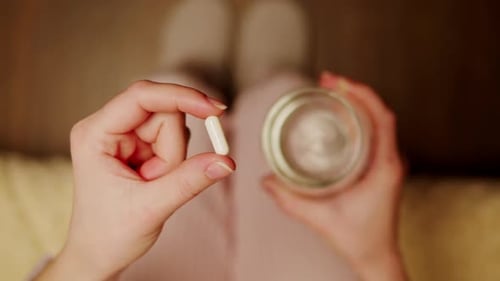Pills and Vitamins Macro Close Up View of Womans Hands Holding Plenty of Different Drugs Painkillers