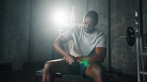 Man Wrapping Hands for Boxing Workout in Gym