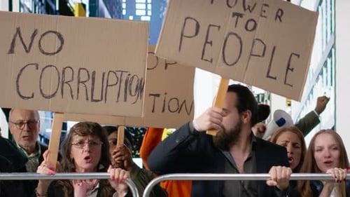 Diverse crowd holds signs at urban protest