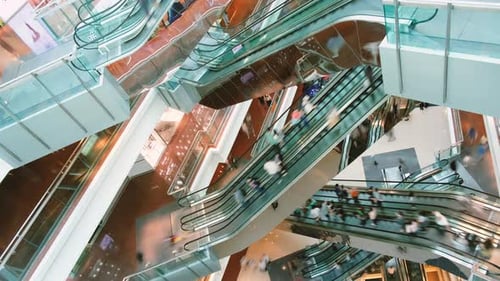 People in escalators at the modern shopping mall. Time lapse.