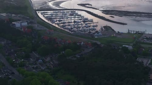 Aerial view of harbour, town, lighthouse by water, Netherlands.