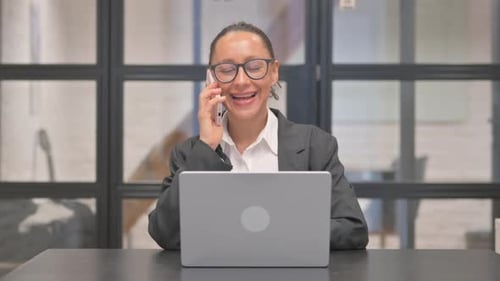 Businesswoman Talking on Phone in Office