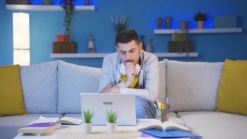 Man biting his nails because of stress at home at night.