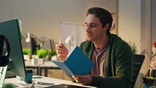 Positive Man Having Virtual Call Modern Office Freelancer Reading Notes Talking
