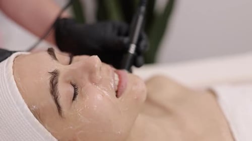 Young Woman Receives Facial Cosmetic Procedure