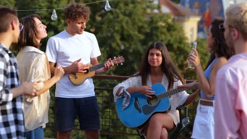 Friends Play Music on Urban Rooftop Gathering