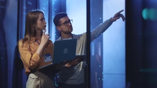 Data Center Engineers Reviewing Servers with Laptop