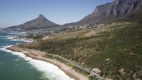 Traffic On The Seaside Road Along Camps Bay Overlooking Twelve Apostles In Cape Town, South Africa.
