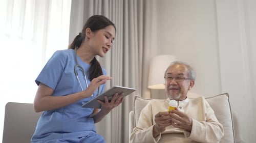Woman Nurse Consults With Senior Man