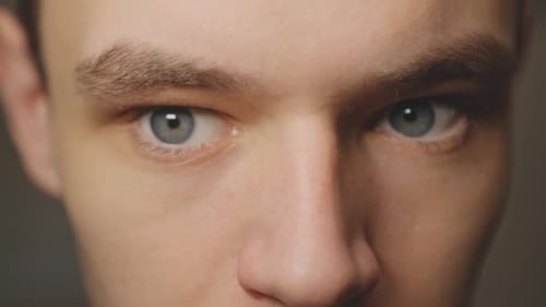 Young Man Facing Too Close To The Camera With Eyes Wide Open - Extreme Closeup Shot