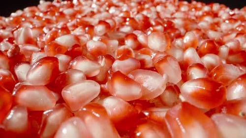 Red pomegranate seeds. Dolly slider extreme close-up.