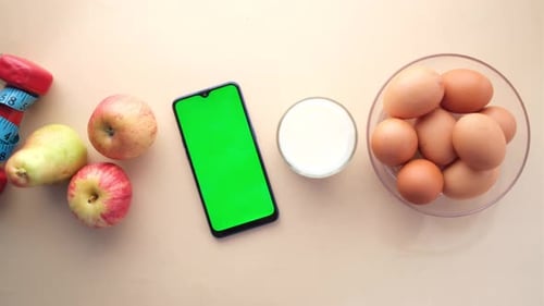 Healthy Items and Cellphone with Green Screen Overhead