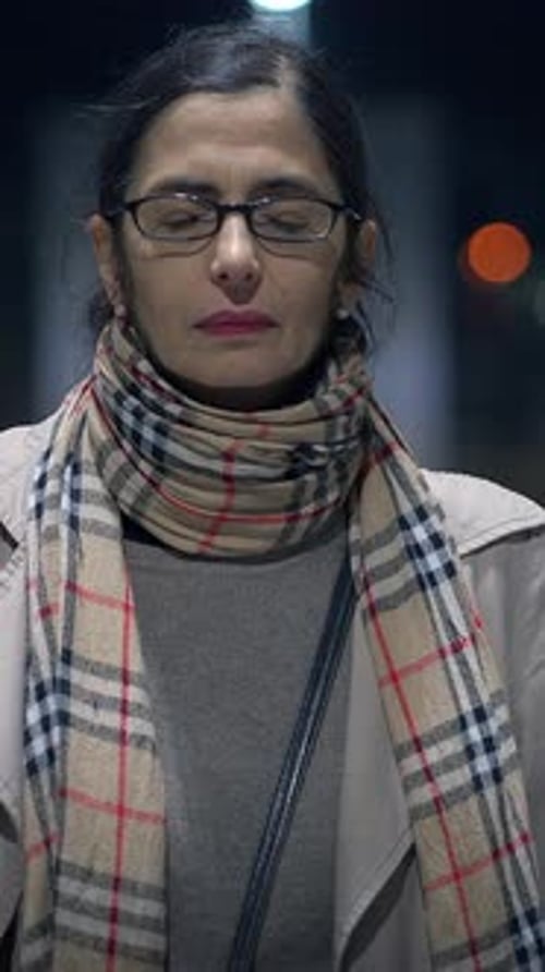 A Thoughtful Woman Surrounded By the Enchanting Urban Nightscape and City Lights