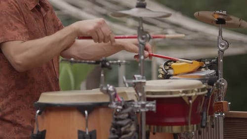 Musician Playing Bongos and Cymbals Outdoors