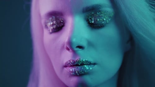 Close Up is a Beautiful Blonde Girl in a Neon Studio Beauty Portrait of a Woman's Face