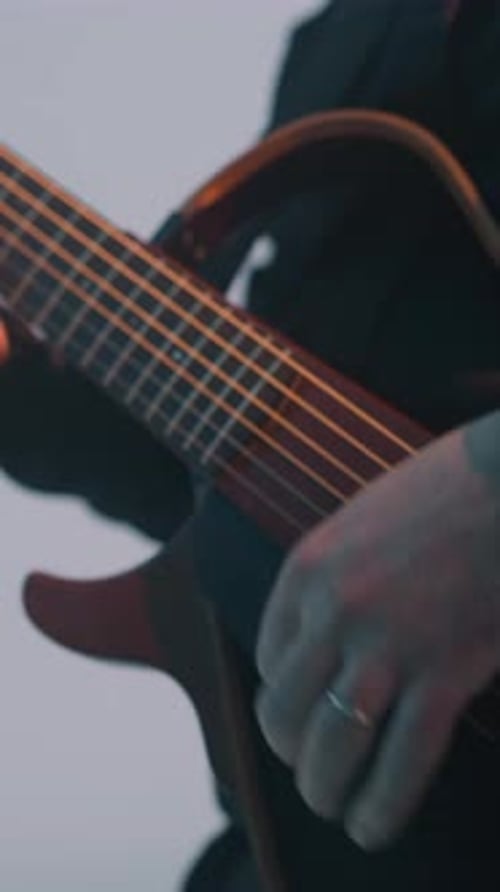Man in Suit Playing Guitar Close Up