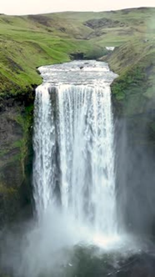 Majestic Waterfall Cascades Down Lush Green Landscape