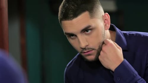 Man Examining Facial Hair in Mirror