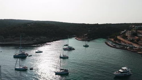Aerial View of Sailboats and Catamarans Anchored in a Secluded Mediterranean Cove