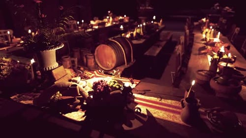 A Vibrant Table Filled with Diverse Food and Drinks Illuminated By Candles