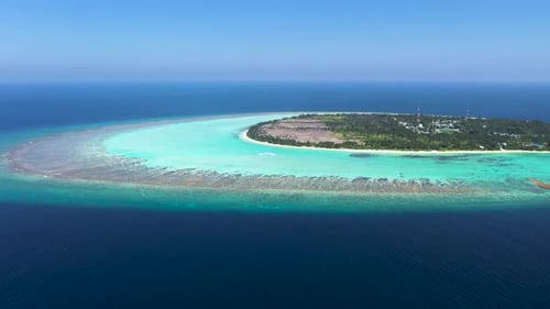 Aerial view of local island with coral reef, Maldives.