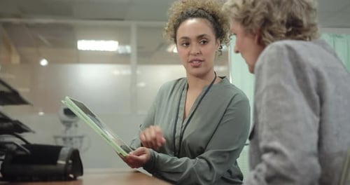 Doctor Discussing Medical X ray in Doctors Office with Senior Patient