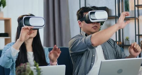 Couple Using VR Headsets in Living Room
