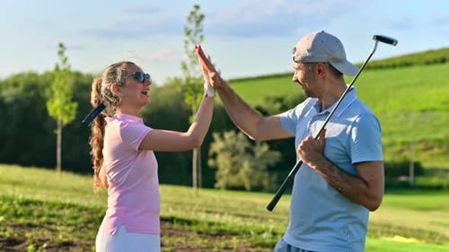 Couple High Five on Sunny Golf Course