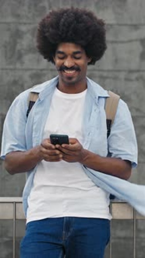 Young African American Man Man Using Smartphone Cell Phone Vertical Video