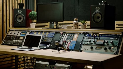 A recording studio control panel mixer with an equalizer faders buttons for broadcasting a recording