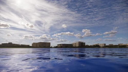 Calm Water Surface with City Horizon and Dynamic Sky