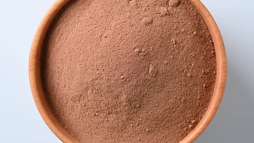 Rotating bowl of cocoa powder