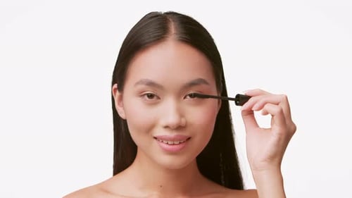 Woman Applying Mascara for Beauty Routine