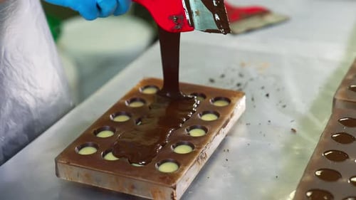 Making Chocolate Candy in Mold with Spatula