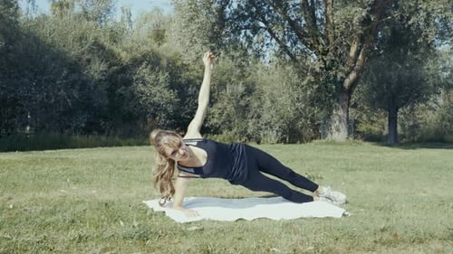 4k shot of young beautiful women doing exercises outdoor in a park at sunrise