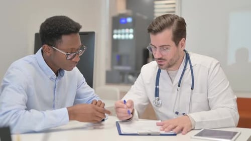 Doctor Discussing Medical Report with Patient in Clinic