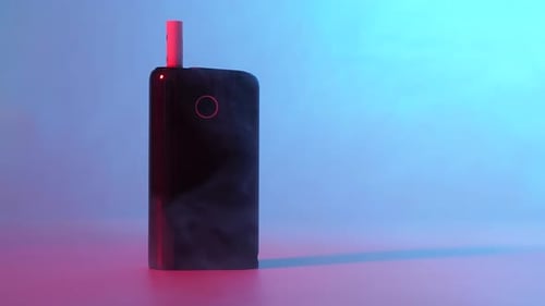 Vape Device on Table with Swirling Fog