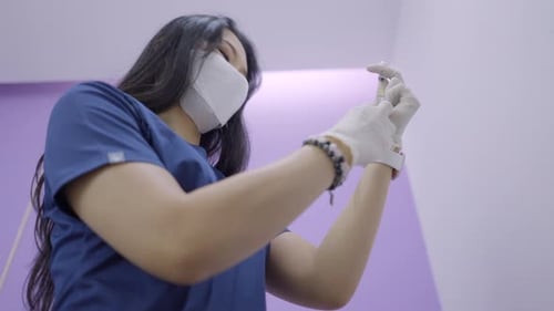 Doctor Extracts Solution From Vial Using Needle for Aesthetic and Anti Aging Therapy