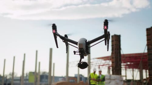 Closeup Shot of Drone Observing Construction Site Blurred View of Construction Workers Wearing