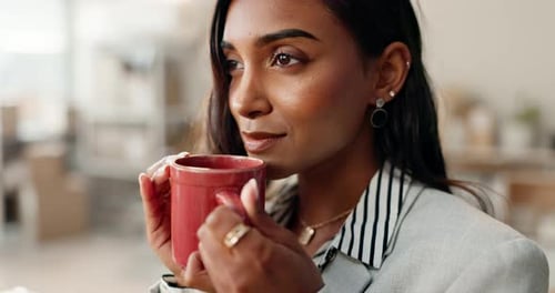 Woman Enjoys Warm Drink at the Office