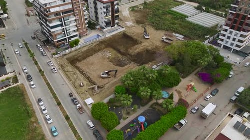 Aerial View TimeLapse of Heavy Machinery Excavating Foundation for a Building