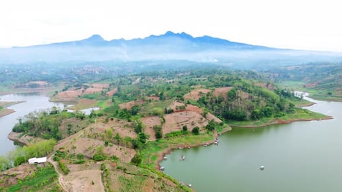 Drone view of natural lake landscape with forest land and mountain