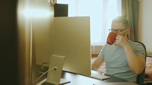 Man Works at Computer in Bright Home Office