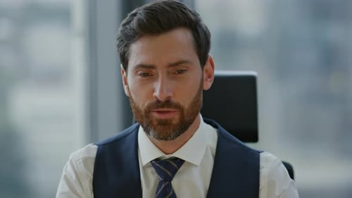 Confident businessman greeting in web camera starting online meeting in modern office