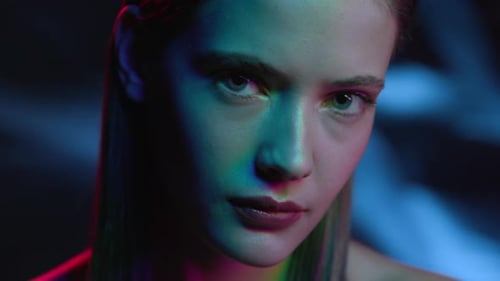 Portrait of Girl Looking at Camera in Colourful Filter. Multi-Colours in Neon